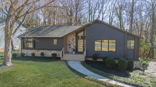 view of front of property featuring stone siding and a front lawn