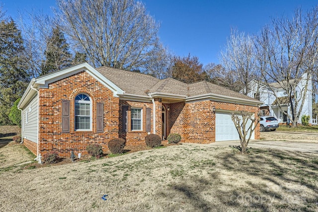 ranch-style house with a garage, a shingled roof, concrete driveway, a front lawn, and brick siding