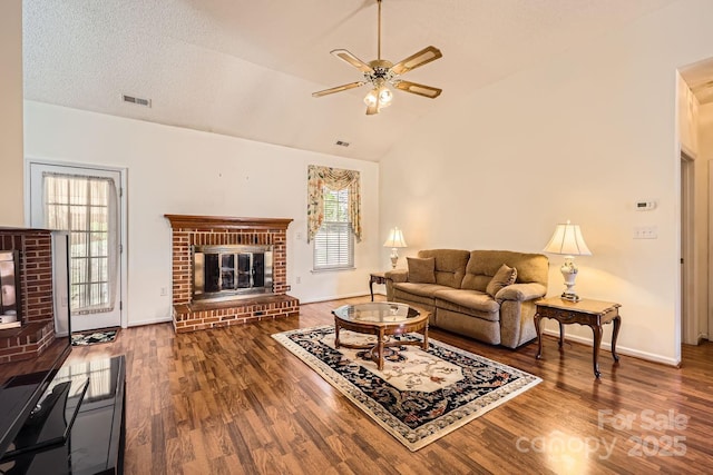 127 Lakewood Circle Dr, Mooresville, NC 28117 - living area featuring lofted ceiling, a brick fireplace, a ceiling fan, and wood finished floors