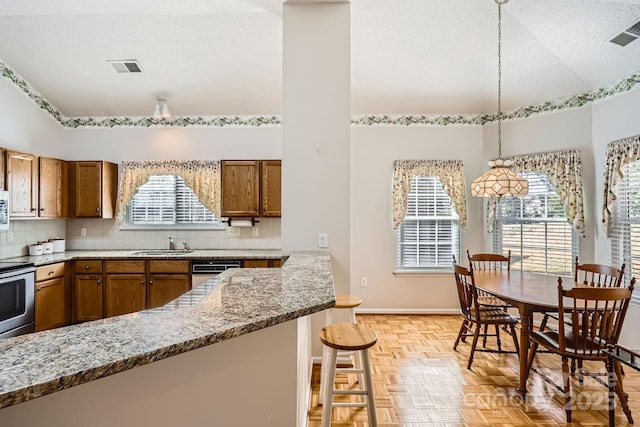 127 Lakewood Circle Dr, Mooresville, NC 28117 - kitchen featuring brown cabinetry, a sink, and backsplash