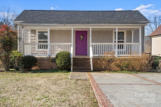 bungalow-style home with a front lawn and a porch