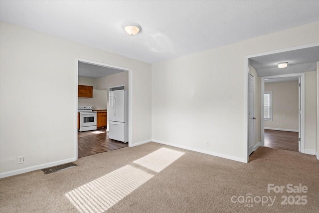 spare room with dark carpet