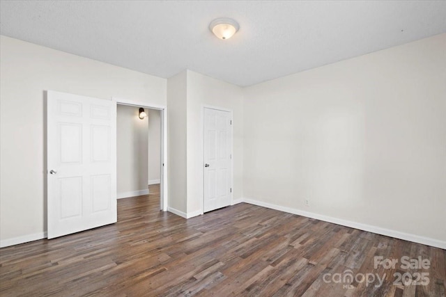 unfurnished bedroom featuring dark wood-type flooring