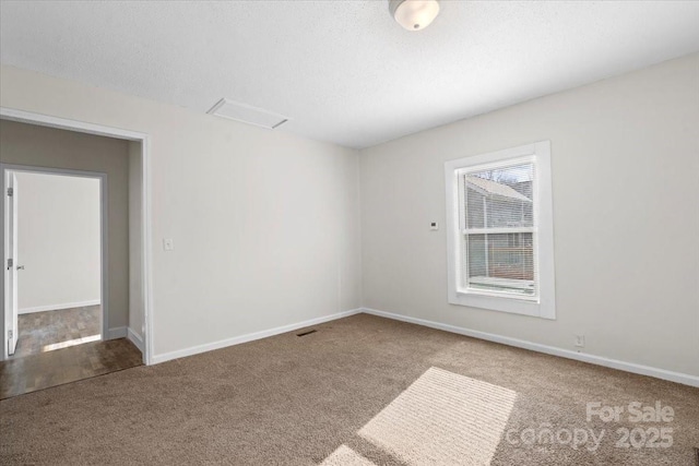 unfurnished room with carpet floors and a textured ceiling