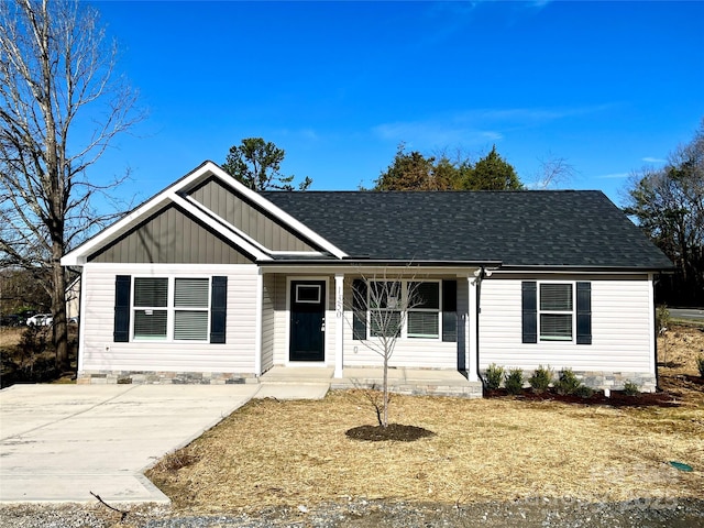 single story home featuring crawl space, covered porch, a shingled roof, and board and batten siding