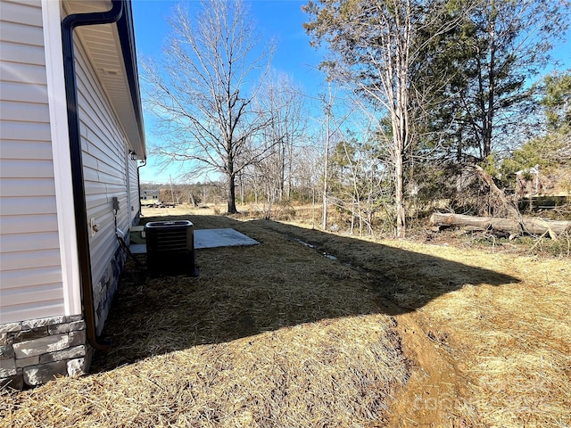 view of yard with central air condition unit