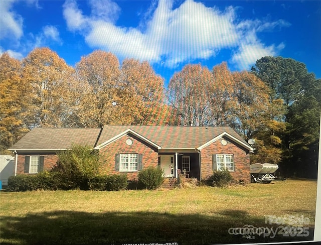 single story home featuring a front lawn