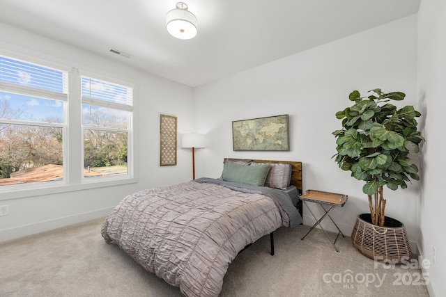 bedroom featuring baseboards, visible vents, and carpet flooring