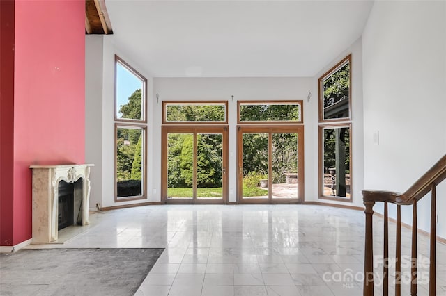 unfurnished living room featuring a high end fireplace