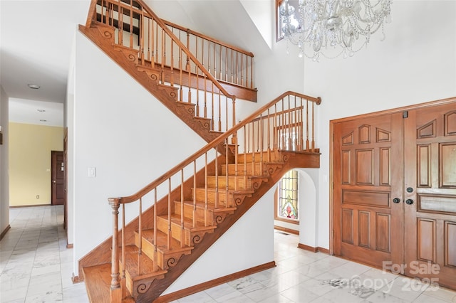 foyer entrance featuring a high ceiling and an inviting chandelier