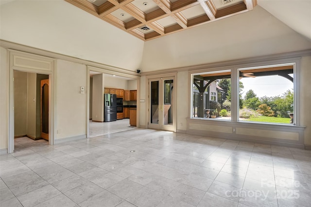 unfurnished room featuring coffered ceiling, ornamental molding, a towering ceiling, and beam ceiling