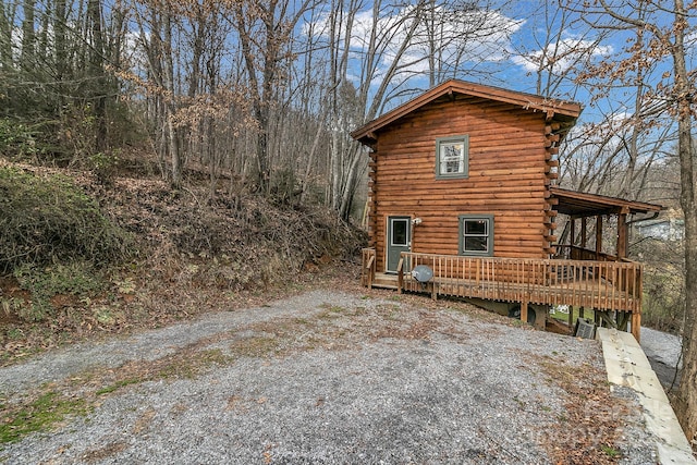 view of property exterior featuring a wooden deck