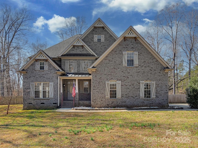 view of front facade featuring brick siding, crawl space, and a front yard