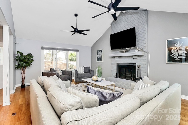 living room with a fireplace, high vaulted ceiling, ceiling fan, and wood-type flooring