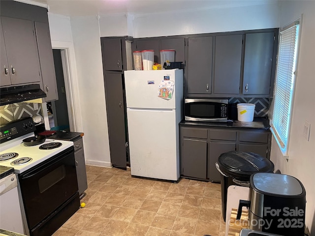 kitchen with range with electric cooktop, dark countertops, stainless steel microwave, freestanding refrigerator, and ventilation hood