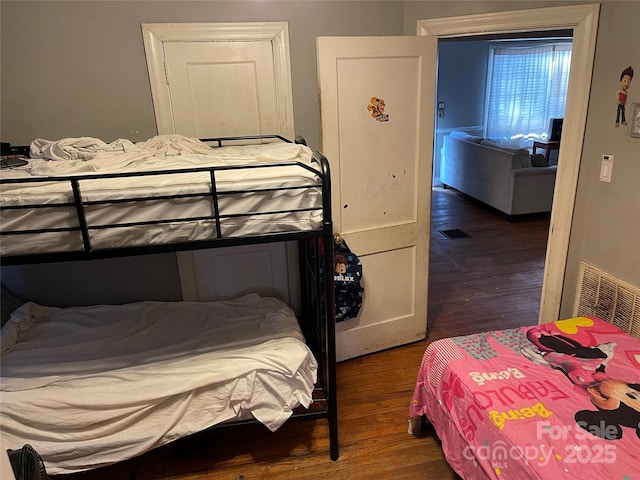 bedroom with visible vents and wood finished floors