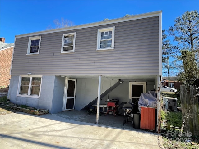 back of house with cooling unit, driveway, and a patio