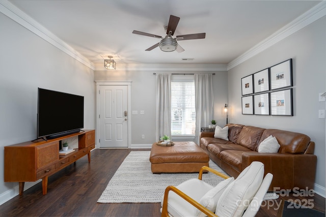 living room with dark wood-type flooring, crown molding, and ceiling fan