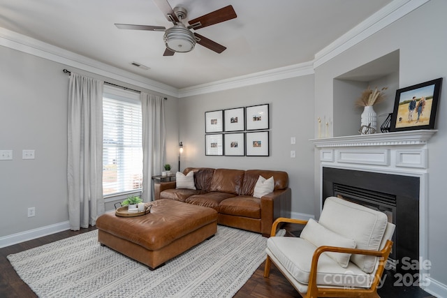 living room with ornamental molding, hardwood / wood-style floors, and ceiling fan