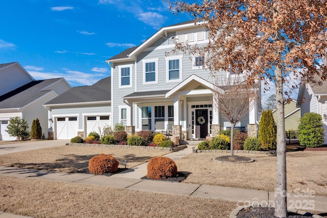 view of front of home featuring an attached garage, a shingled roof, and concrete driveway