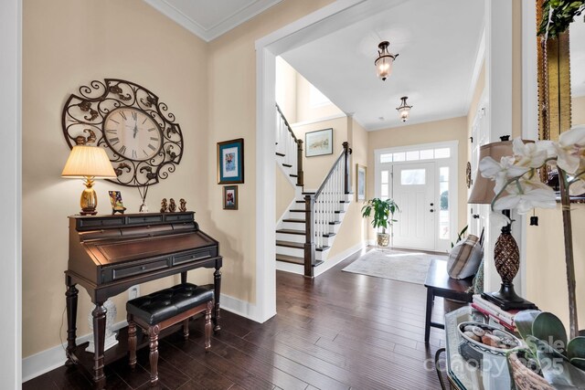 entryway featuring dark wood-style floors, baseboards, stairs, and crown molding