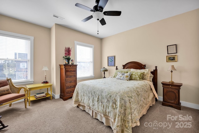 bedroom with a ceiling fan, light carpet, visible vents, and baseboards