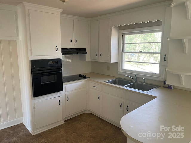 kitchen featuring sink, black appliances, and white cabinets