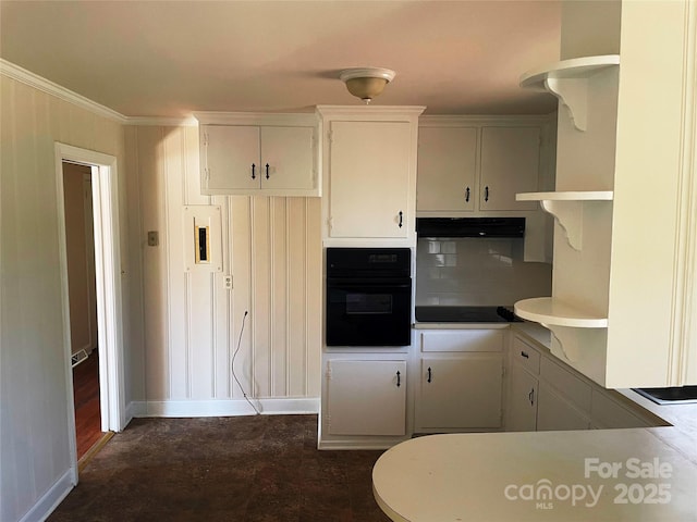 kitchen with tasteful backsplash, white cabinetry, crown molding, and black appliances