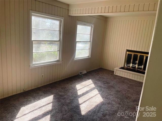 unfurnished room featuring dark colored carpet