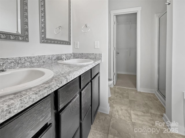 bathroom with vanity and a shower with door