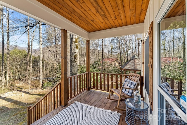 sunroom featuring wood ceiling