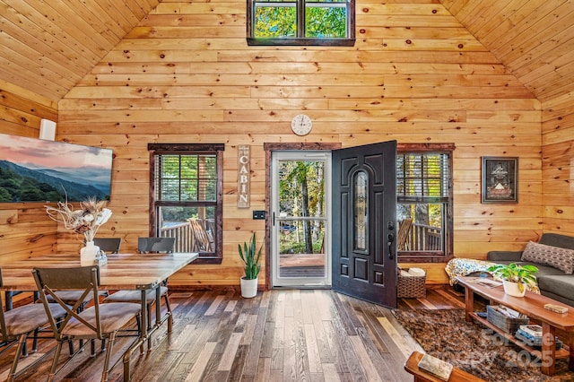 interior space featuring high vaulted ceiling, wooden ceiling, wood walls, and wood finished floors