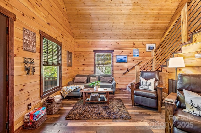 living room with stairway, wooden walls, high vaulted ceiling, wooden ceiling, and hardwood / wood-style flooring