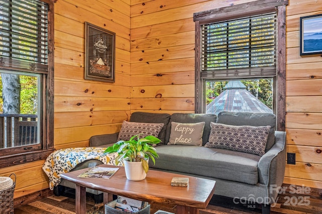 living room featuring wooden walls and wood finished floors