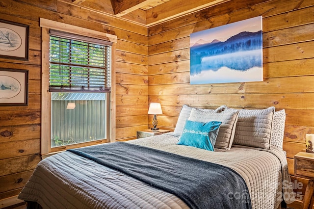 bedroom featuring wood walls