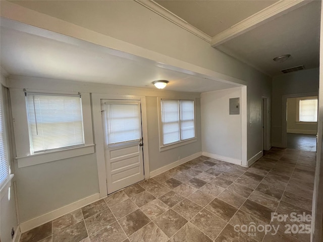 foyer entrance with baseboards, electric panel, visible vents, and ornamental molding