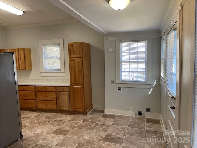 washroom with baseboards, a healthy amount of sunlight, washer hookup, and hookup for an electric dryer