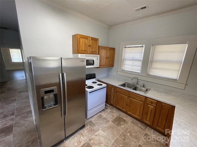 kitchen with white appliances, crown molding, visible vents, and a wealth of natural light