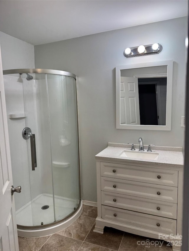 bathroom with a stall shower, tile patterned flooring, and vanity