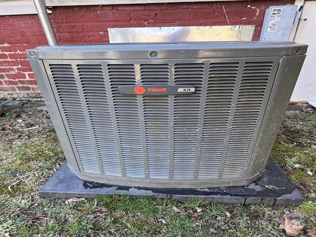 details with central AC unit and brick siding