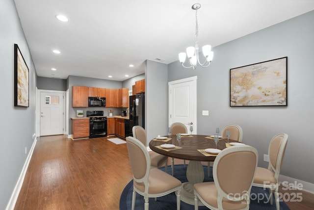 dining area with a chandelier and dark hardwood / wood-style flooring