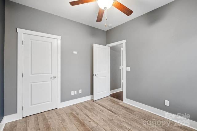 unfurnished bedroom with ceiling fan and light wood-type flooring