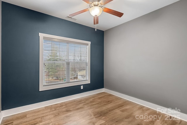 unfurnished room with hardwood / wood-style flooring and ceiling fan