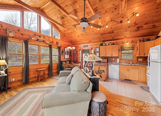 living area featuring wooden ceiling, wooden walls, light wood-style flooring, and high vaulted ceiling