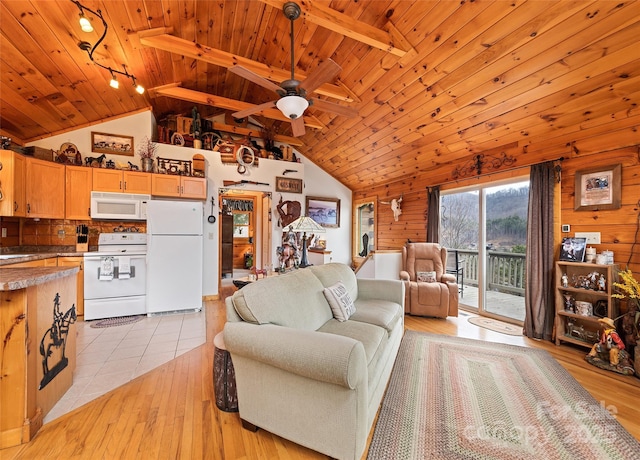 living area featuring light tile patterned floors, lofted ceiling, wood ceiling, and wood walls