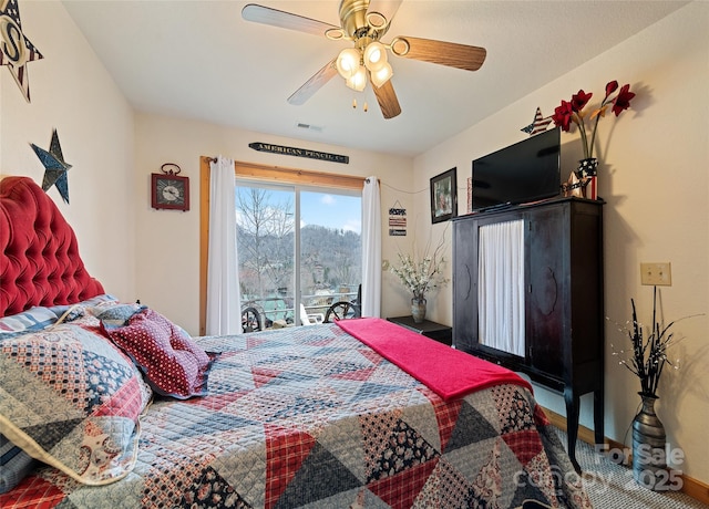 bedroom featuring access to exterior, visible vents, baseboards, and a ceiling fan