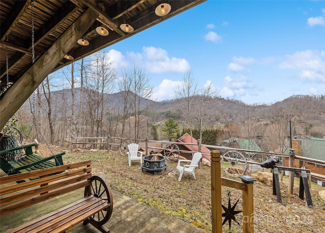 exterior space with a mountain view and a fire pit