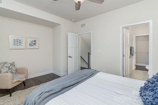 bedroom with light wood-style floors, visible vents, ceiling fan, and baseboards