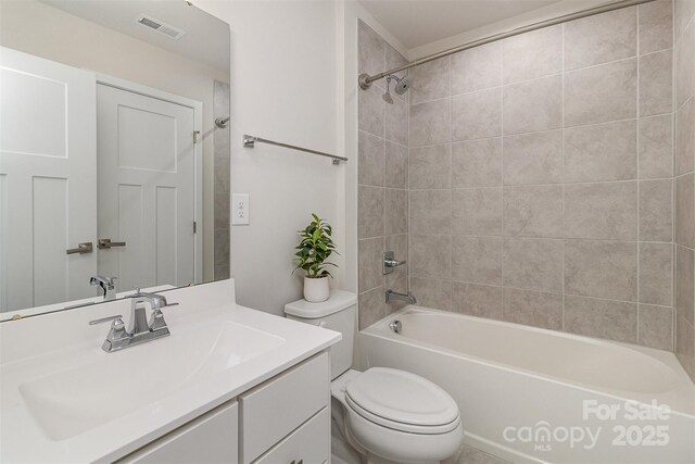 bathroom with toilet, shower / tub combination, visible vents, and vanity