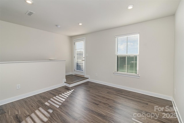 unfurnished room featuring dark wood-style floors, recessed lighting, and baseboards